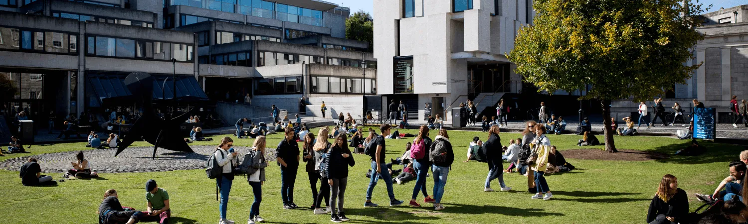 Students walking on Fellow's Square in front of the Arts Building.
