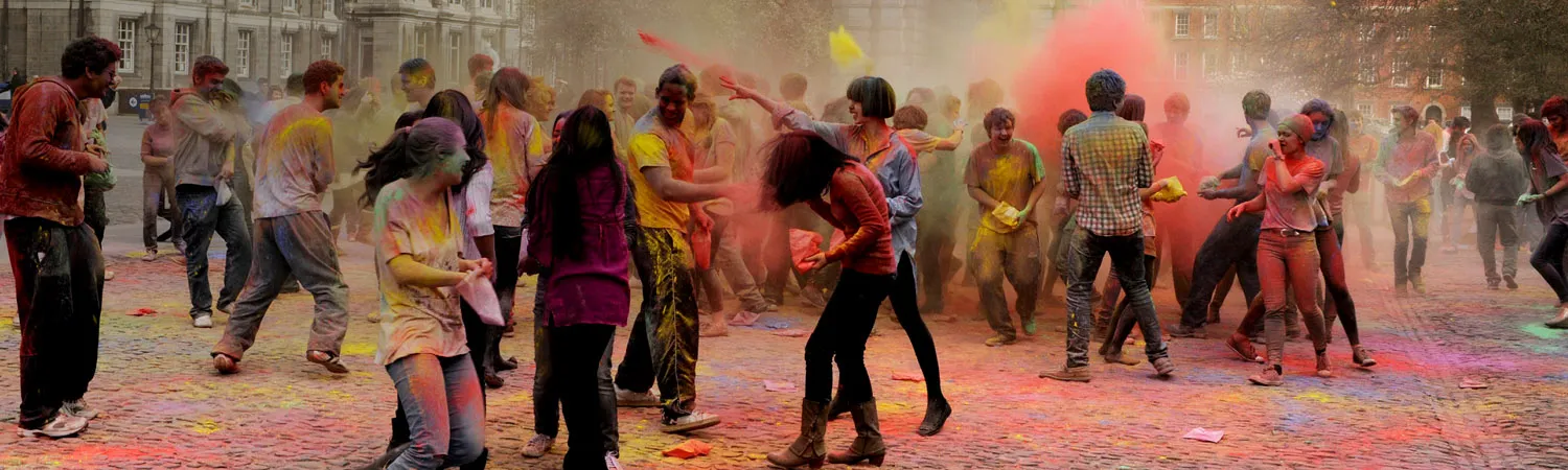 Students covered in dye celebrate Holi festival on campus