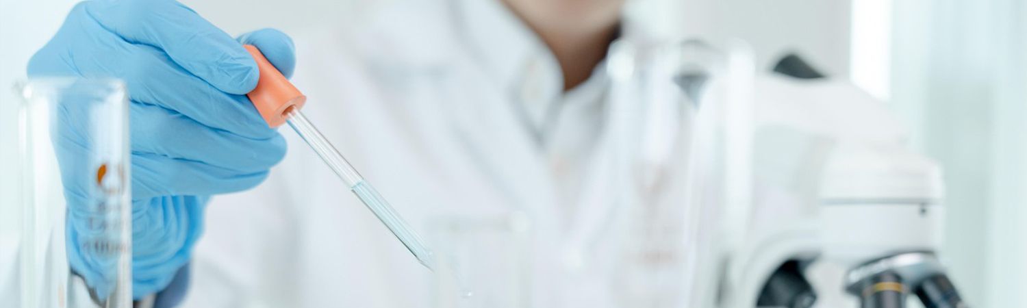 Lab worker holding dropper