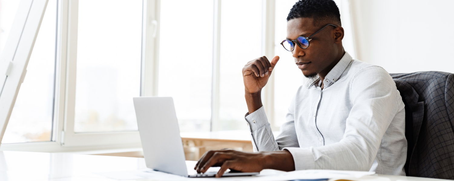 image of a man sitting at a computer