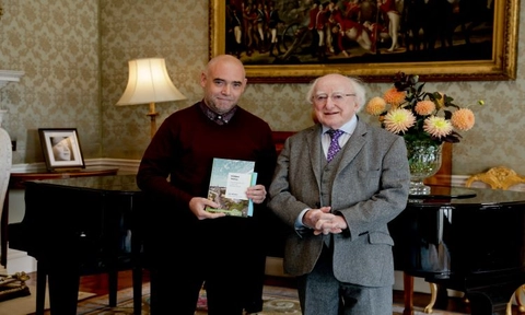 Dr Joe Whelan presents book to President Higgins