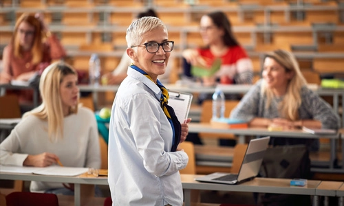 Lecturer engaging with students in a classroom setting