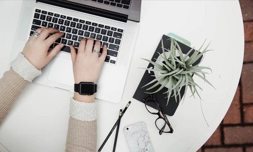 Person typing at a laptop
