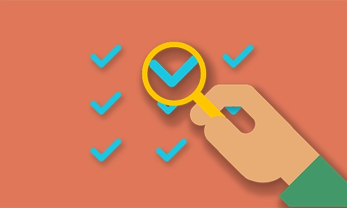 A cartoon graphic of a magnifying glass and some tick marks.