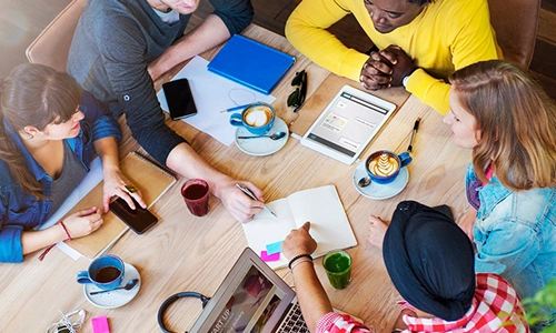 students around desk aerial view