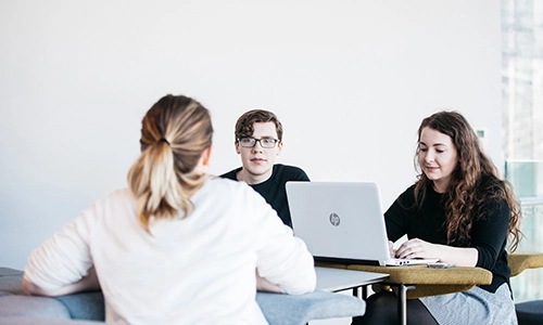Three students on laptops
