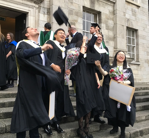 Students graduating on the steps of the Exam Hall