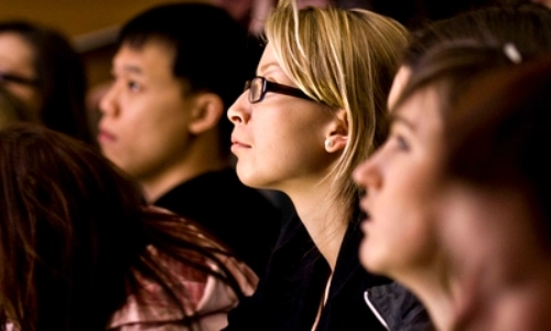 Three students listening to a lecture