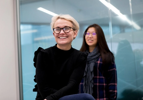 Two research collaborators standing beside eachother