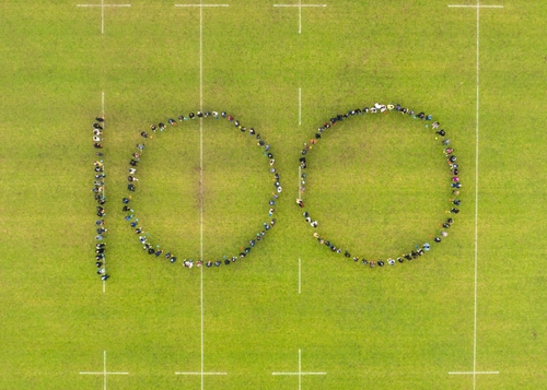 Trinity Business School staff and students form the number 100 to mark the School's centenary year.