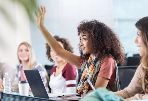 Female student raising her hand during a lecture