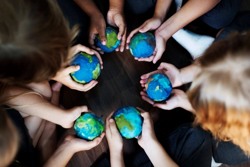 Group of hands holding cupping globe