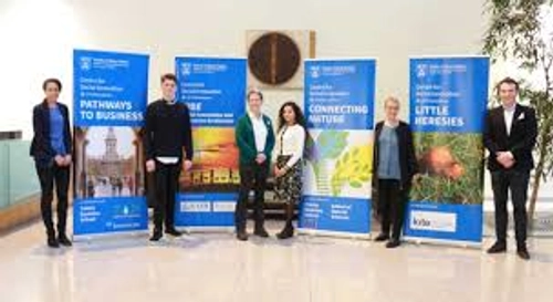 Photo of people standing next to poster banners