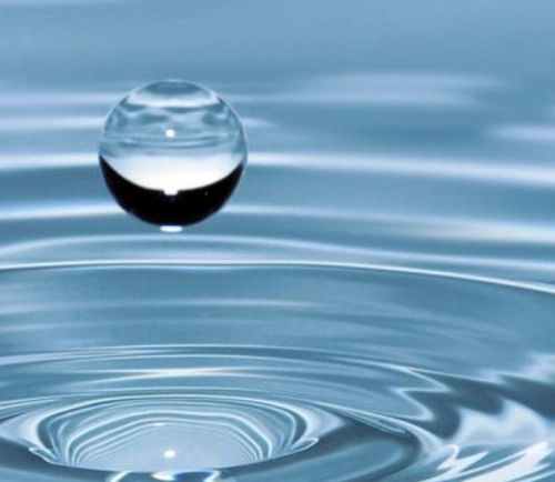 A drop of water floating over water with another drop shape