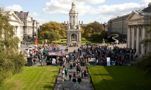 An image of Front Square, Trinity College Dublin, with lots of people and gazebos set up for Freshers' week