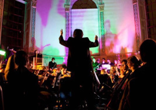 Conductor conducting and orchestra