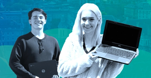 student holds laptop towards camera