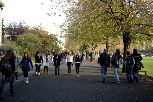 Students walking through Trinity College Dublin campus.