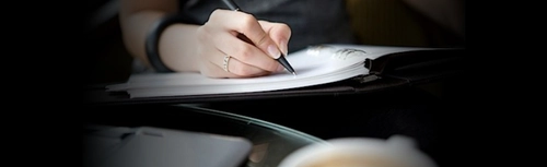 A person writing in a book