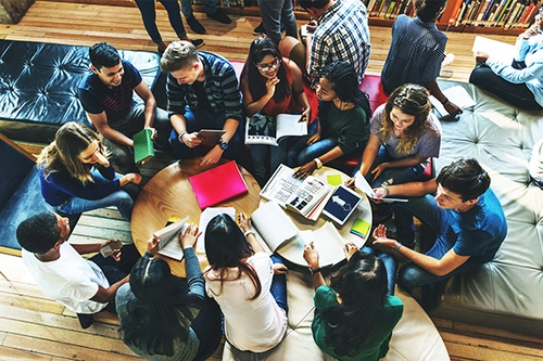 Undergraduate Students sitting around a table collaborating
