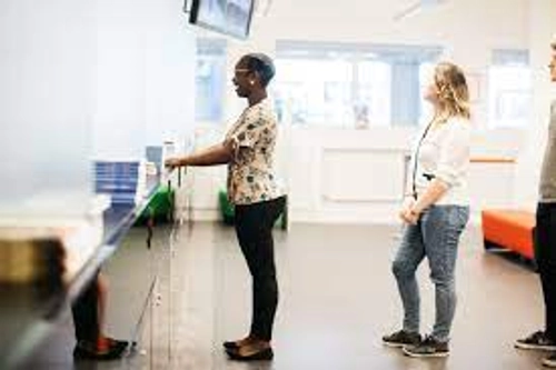 Two students queuing up at Academic Registry