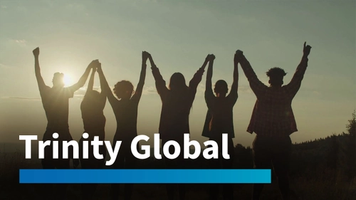 Silhouettes of people holding hands up in the air. Trinity Global