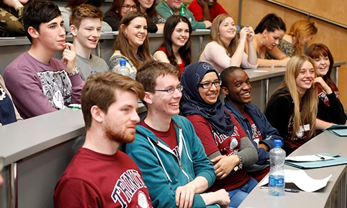 students sitting in tiered lecture hall