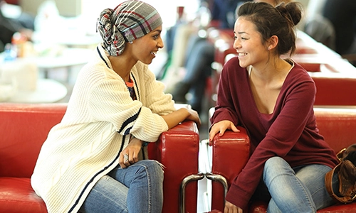 seated students chatting closely