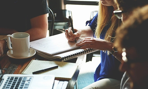 girl taking notes at desk