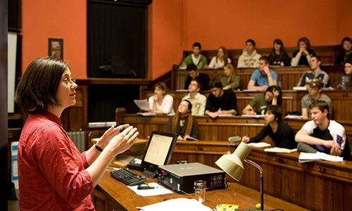 Professor speaking to students in lecture theatre