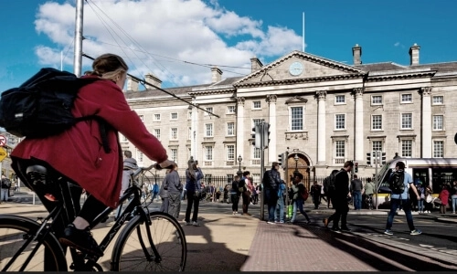 A person cycling in the direction of Trinity