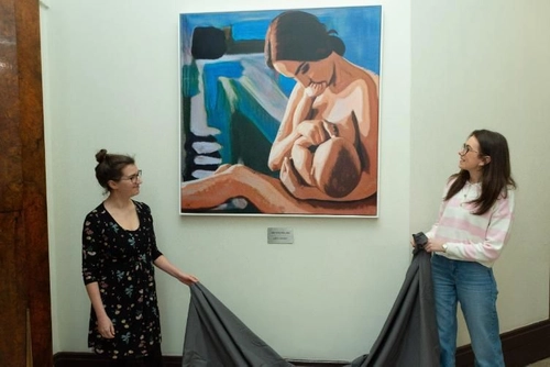Students unveiling breastfeeding mural