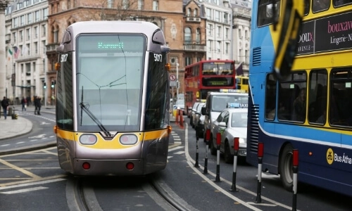 A Luas tram and a bus outside College Green
