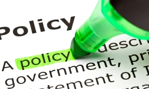 A marker pen highlighting the word Policy