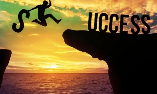 Image of a person jumping from one cliff ledge to another