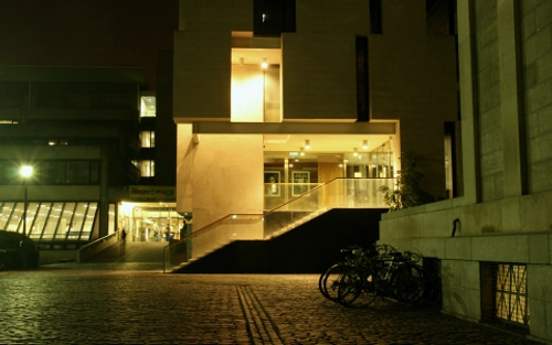 Trinity Long Room Hub, illuminated in the evening.
