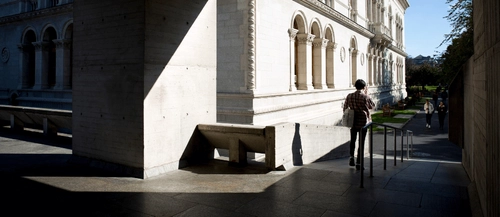 A student walking down a ramp from the Boland Library.