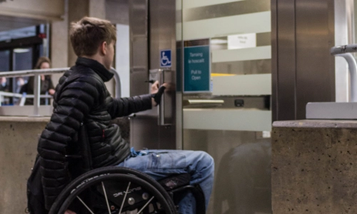 A student in a wheelchair, using the lift in the Arts Building.
