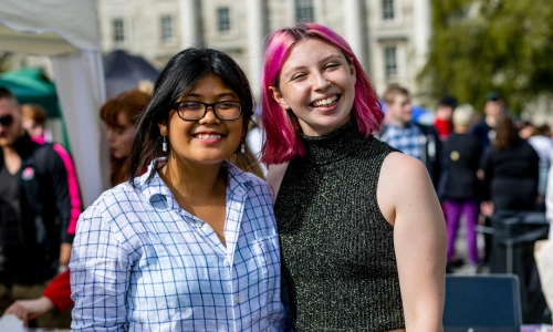 Two students smiling together in Front Square.