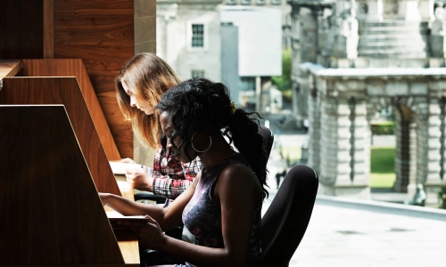 Two students studying in the Eavan Boland Library.