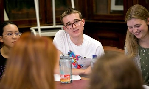 Three students sitting around a table.