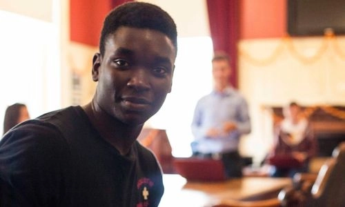 A smiling student in a class.