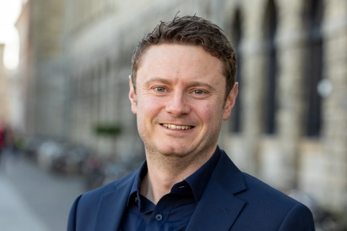 Brian Barry in front of a TCD building