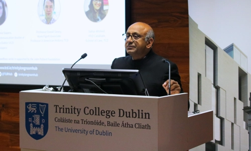 Premesh Lalu presenting at a podium for a Behind the Headlines discussion