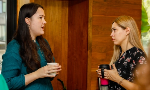 Two women speaking to each other at the Long Room Hub