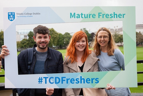 Mature Students holding a mature fresher sign