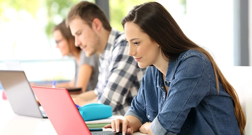 Students working on their laptops in College