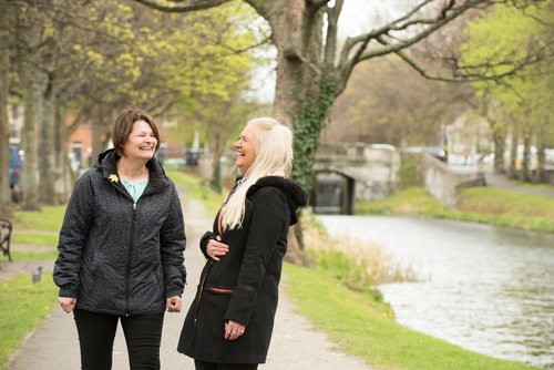 We Can Quit2 poster: two people laughing in a park by a river