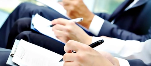 People note taking at a meeting