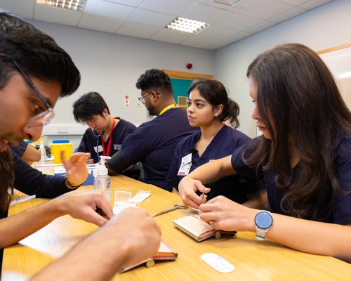 students practicing clinical skills on each other